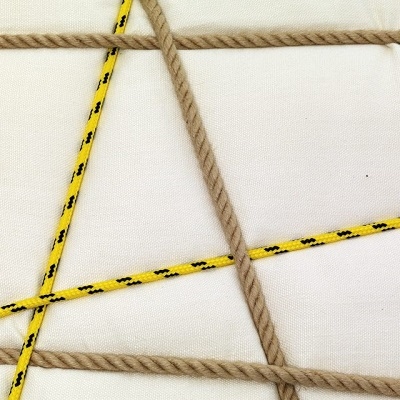 A_white fabric / yellow and natural rope
